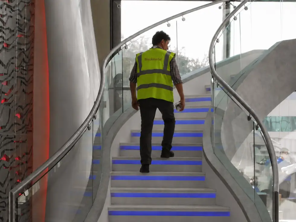 Curved stainless steel and glass balustrade on an architectural staircase